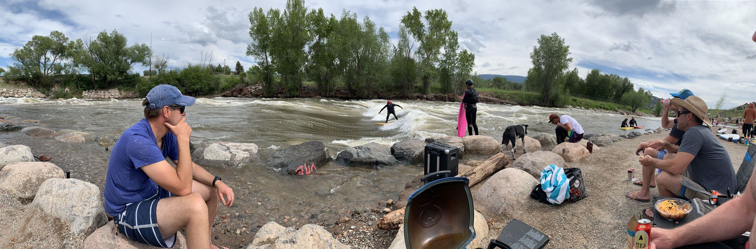 Surfers and spectators gathered along the Eagle River wave